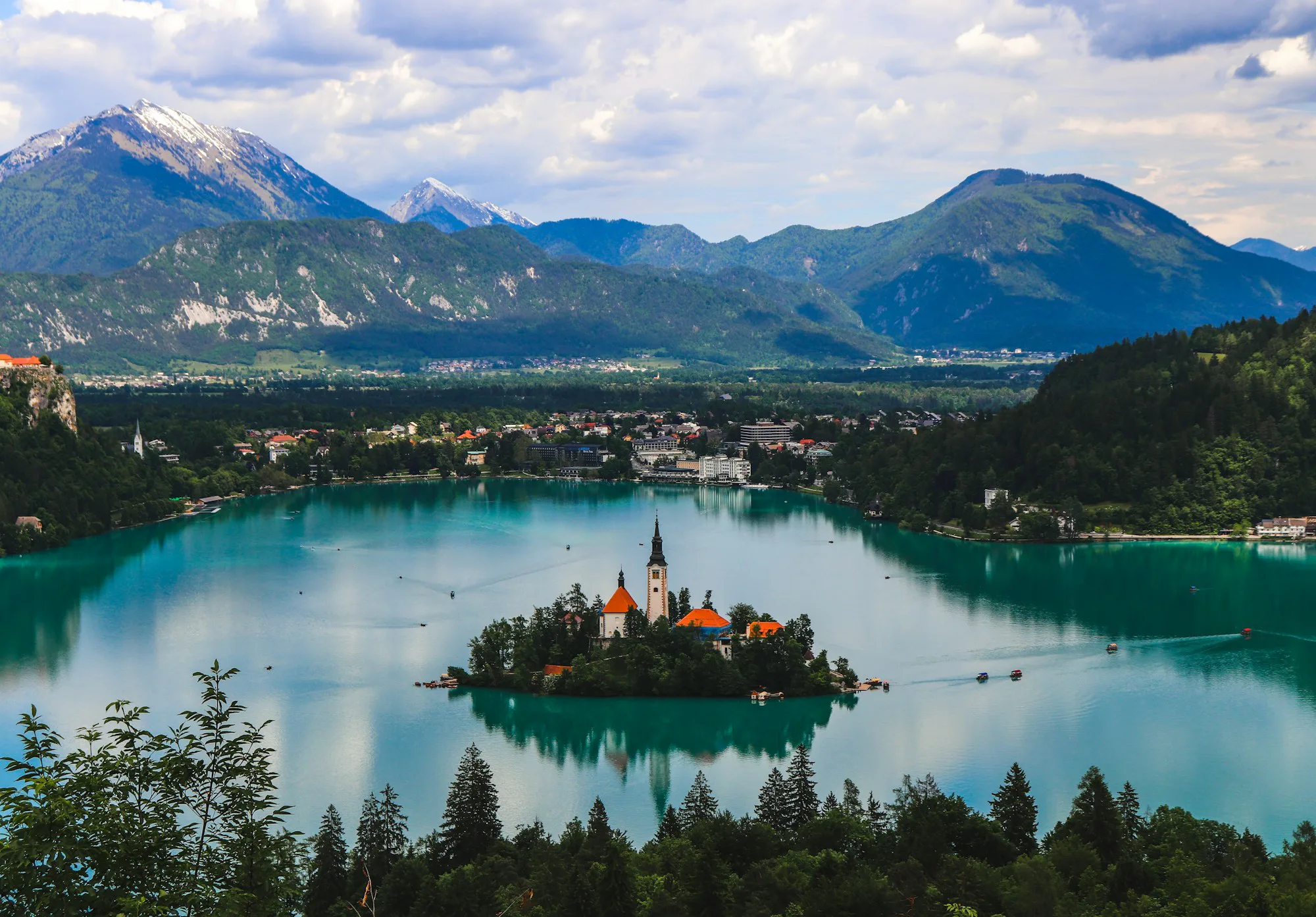 Lake Bled and its island seen from above, with mountains around