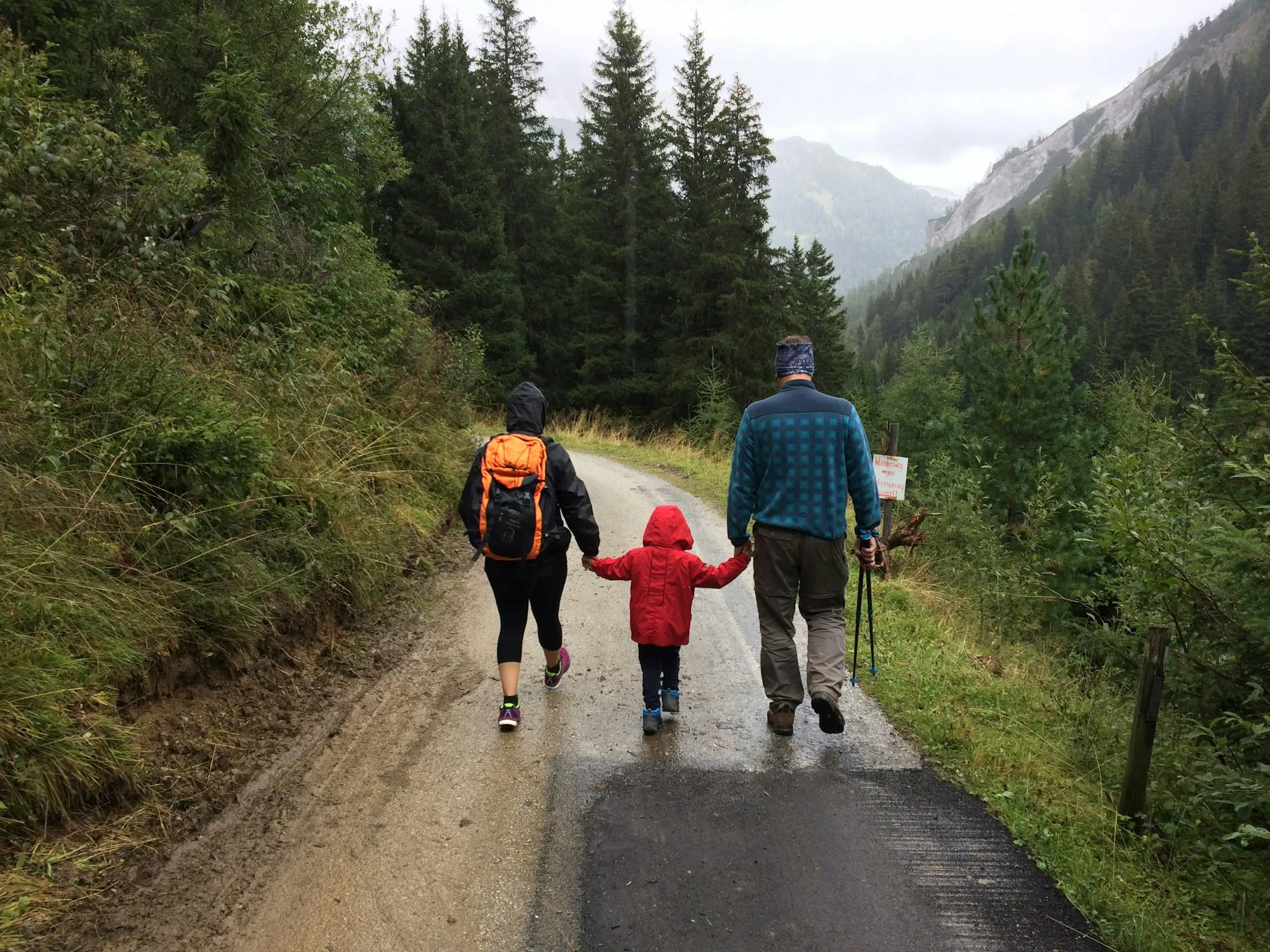 A family walking together along a dirt road