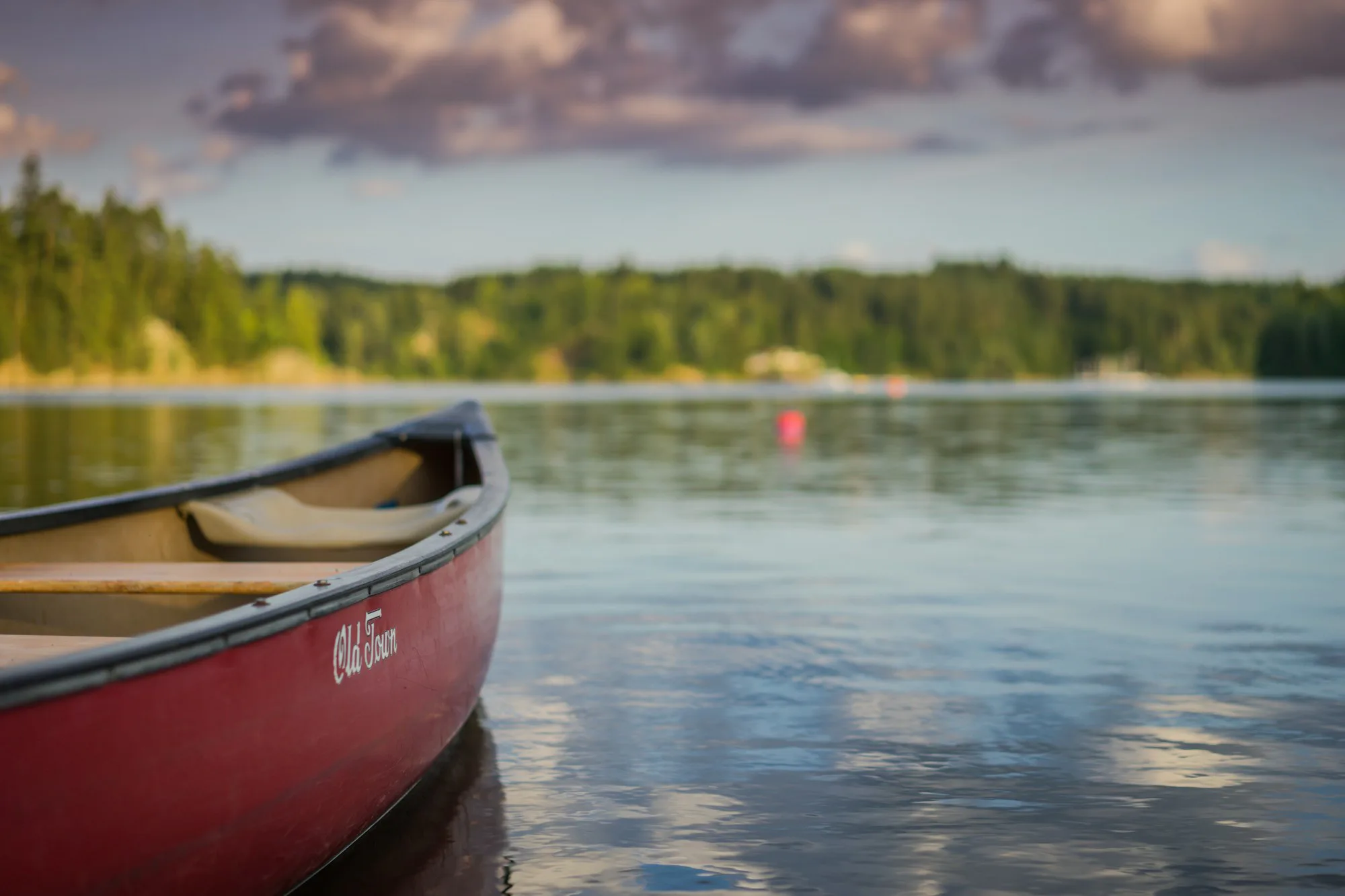 A red canoe on still water