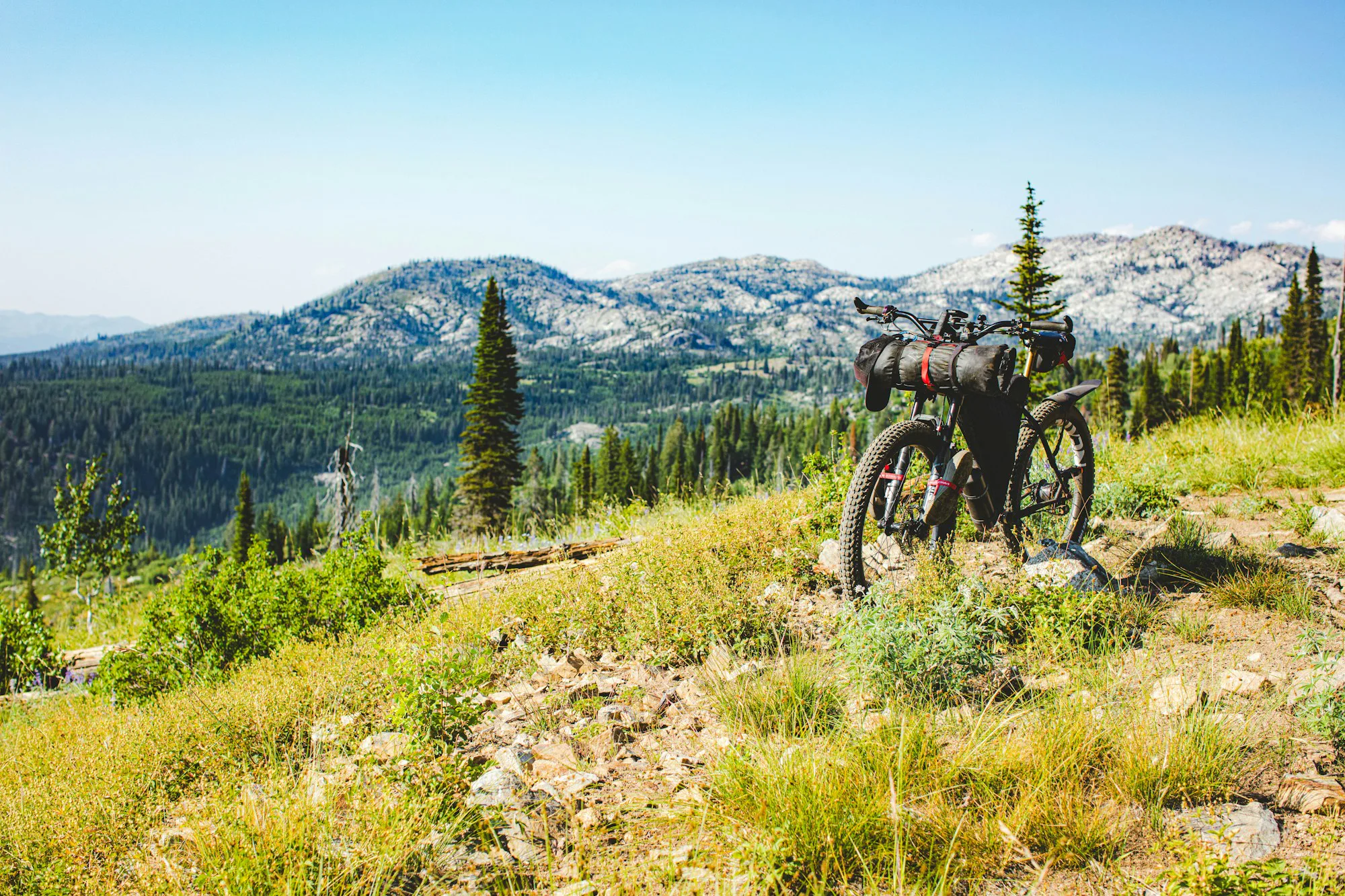 A loaded bikepacking bike on a mountain trail