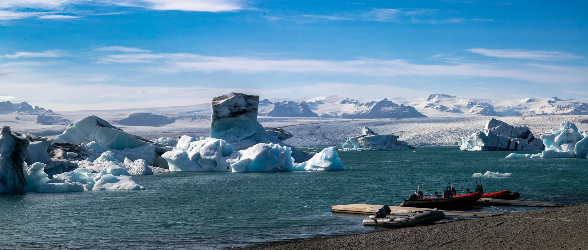 Icebergs on a glacier lagoon under a blue sky