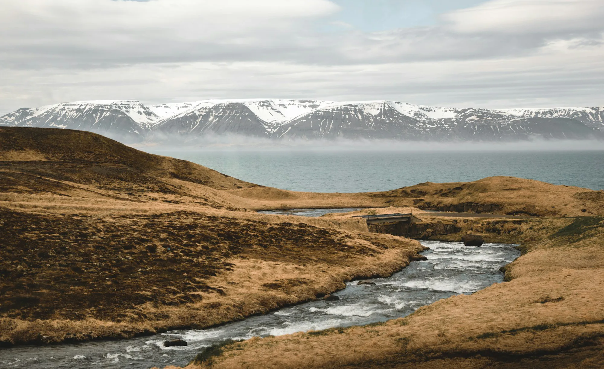 A stream winding through a wide highland valley