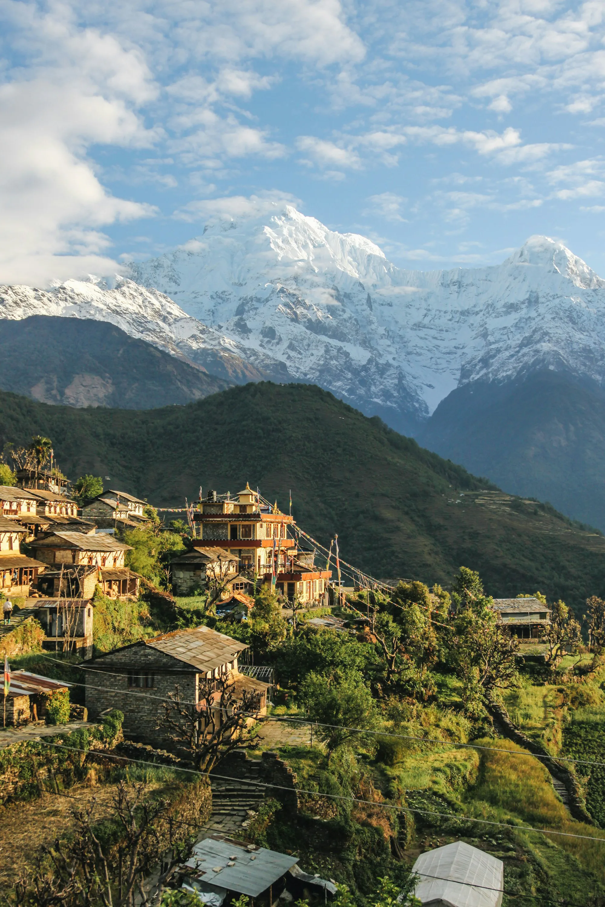 Stone houses of a hill village overlooking snowy mountains