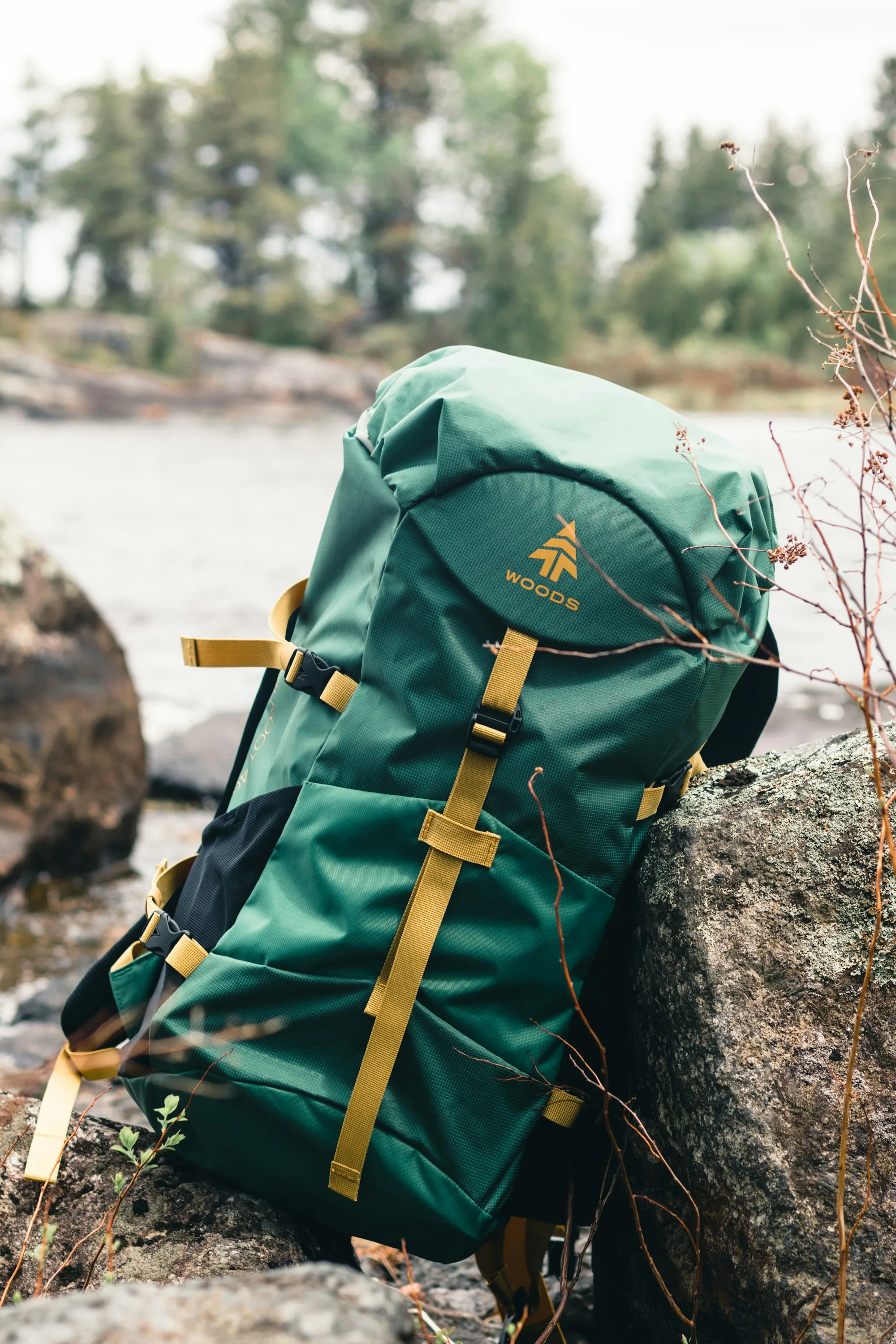 A green and brown backpack on a rock