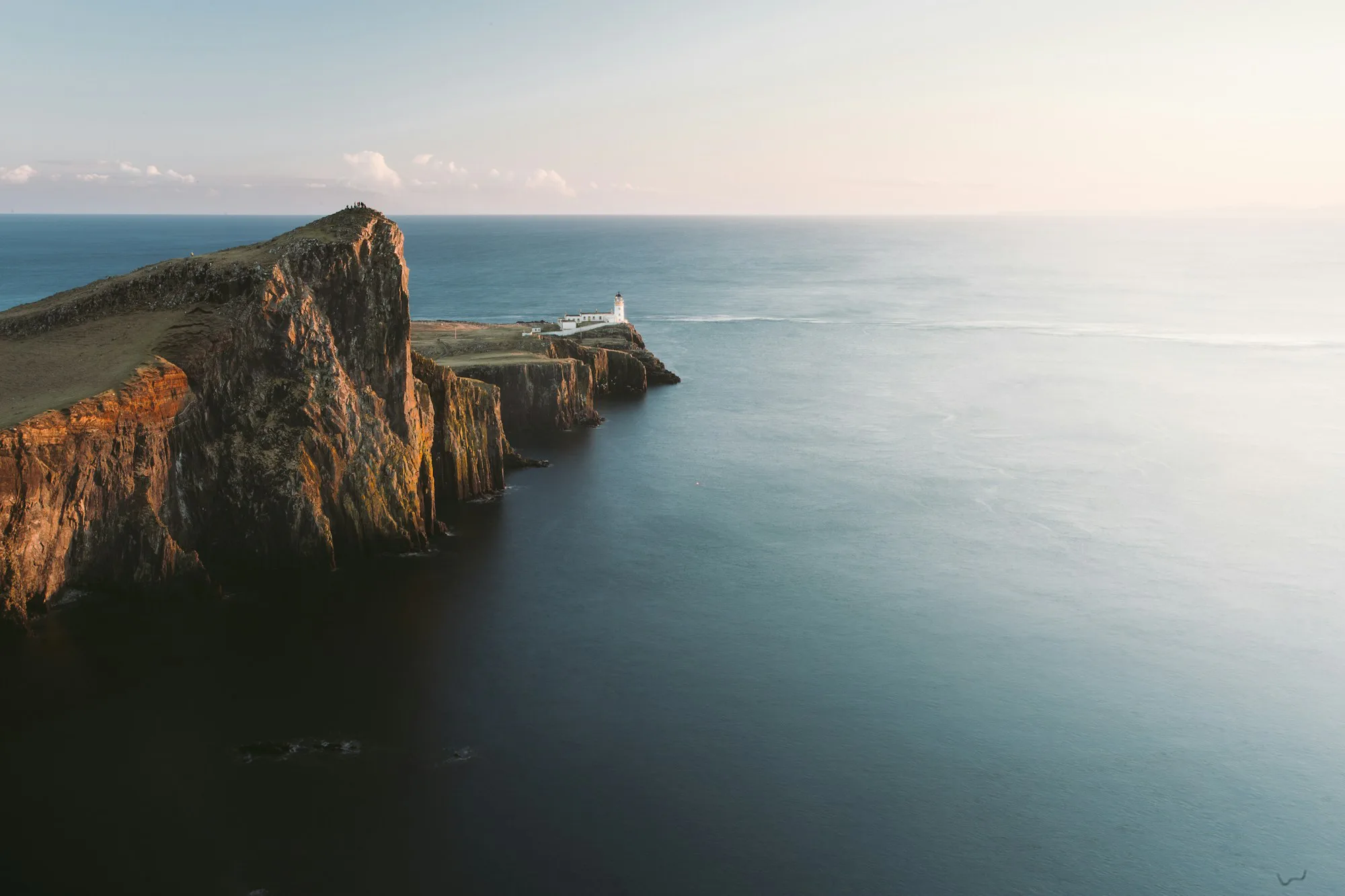 Neist Point lighthouse on a cliff above the sea