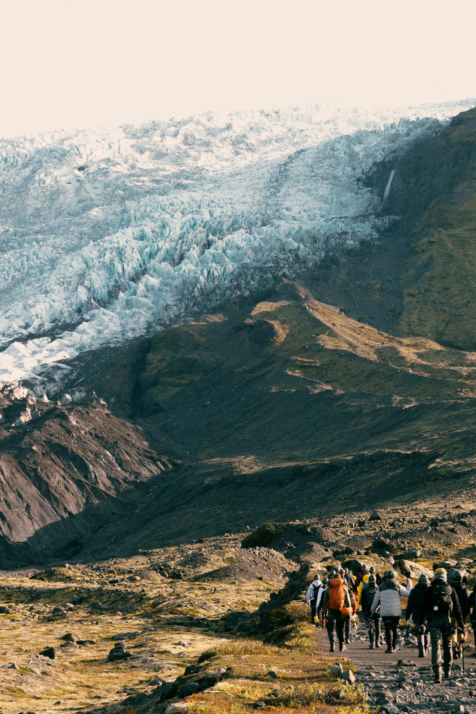 An icefall pouring down between rocky mountain ridges