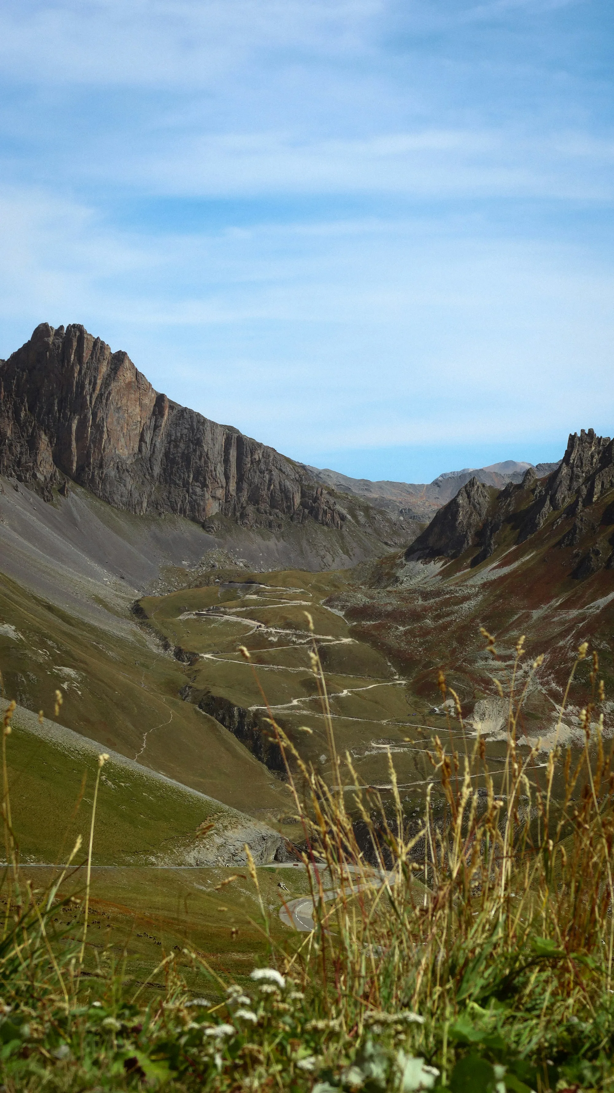 Switchbacks climbing a wide alpine valley