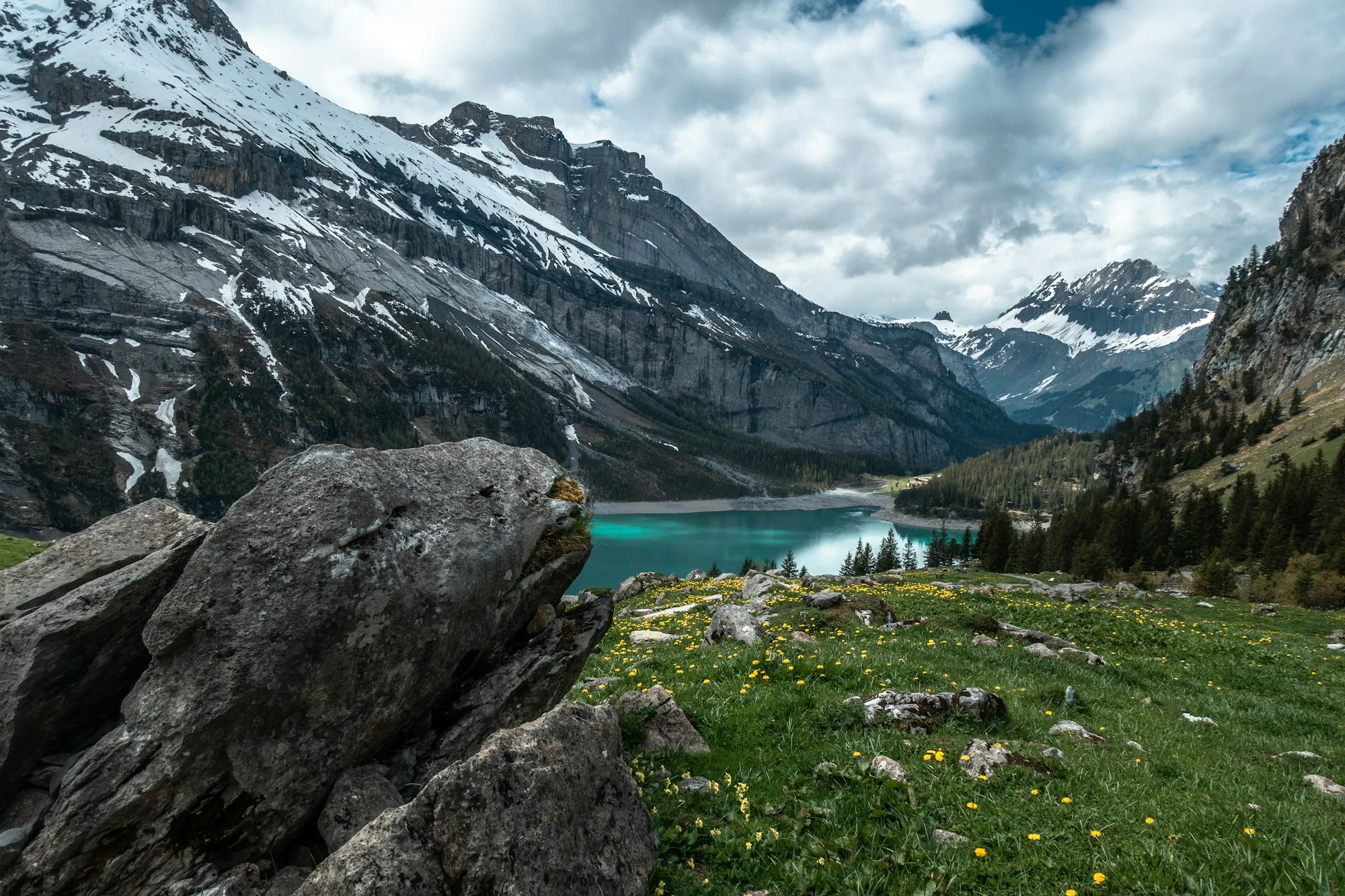 The Oeschinensee lake below snow-capped peaks near Kandersteg