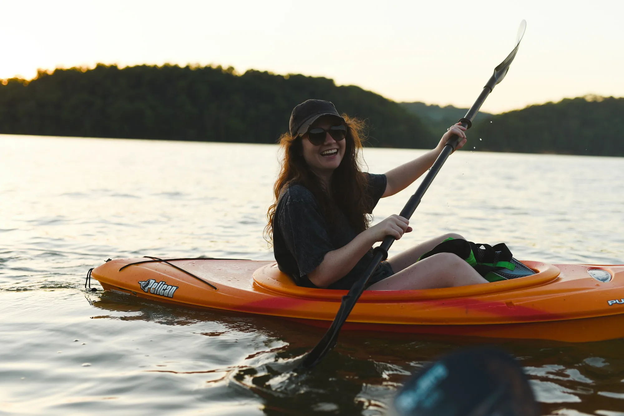 An orange kayak on a calm lake